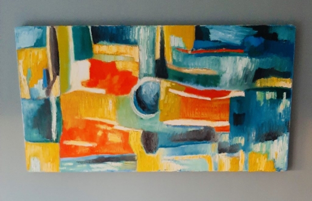 An abstract painting with cuboid-ish blocks of orange, yellow, and blue.